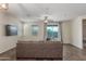 Bright living room with wood-look floors, neutral walls, and a sliding glass door at 17296 W Molly Ln, Surprise, AZ 85387