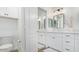 Modern bathroom features white cabinets, a framed mirror, and contemporary lighting fixtures at 17827 N 51St Way, Scottsdale, AZ 85254