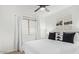 Bright bedroom with a ceiling fan, modern artwork, and plush white bedding at 17827 N 51St Way, Scottsdale, AZ 85254