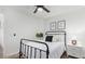 Cozy bedroom with a black metal bed frame, white bedding, and matching nightstand at 17827 N 51St Way, Scottsdale, AZ 85254