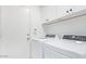 Bright laundry area with white cabinets, modern washer and dryer at 17827 N 51St Way, Scottsdale, AZ 85254
