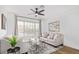 Cozy living room featuring a comfortable sofa, large window, and stylish decor at 17827 N 51St Way, Scottsdale, AZ 85254