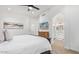 Bright and airy bedroom with view into bath, modern décor, and ceiling fan at 17827 N 51St Way, Scottsdale, AZ 85254