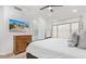 Modern bedroom featuring a TV, dresser, window and archway leading to main bath at 17827 N 51St Way, Scottsdale, AZ 85254