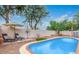 Backyard features a sparkling pool, lounge chairs, and lush landscaping at 17827 N 51St Way, Scottsdale, AZ 85254