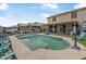 Spacious backyard with a pool, outdoor seating and a covered patio perfect for outdoor gatherings and enjoyment at 17935 W Louise Dr, Surprise, AZ 85387