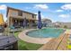 Backyard featuring a private pool, covered patio, and artificial grass for easy maintenance at 17935 W Louise Dr, Surprise, AZ 85387