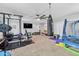 Spacious basement featuring a home gym with carpet, a punching bag and some workout equipment at 17935 W Louise Dr, Surprise, AZ 85387