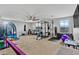 Spacious basement featuring a home gym with carpet and multiple windows at 17935 W Louise Dr, Surprise, AZ 85387