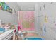 Bright bathroom featuring a pink Minnie Mouse shower curtain and decorations at 17935 W Louise Dr, Surprise, AZ 85387