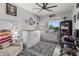Bright bedroom with a large window, cozy furniture, and stylish decor at 17935 W Louise Dr, Surprise, AZ 85387