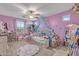 Girly bedroom with a bed under a blue canopy and a circular rug on the carpeted floor at 17935 W Louise Dr, Surprise, AZ 85387