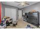 bedroom featuring a ceiling fan, dresser, and closet at 17935 W Louise Dr, Surprise, AZ 85387