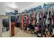 Walk-in closet with organized shelving and hanging rods that maximize storage space for clothes, shoes and luggage at 17935 W Louise Dr, Surprise, AZ 85387