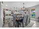 Dining area with designer lighting, backyard views, and modern accents at 17935 W Louise Dr, Surprise, AZ 85387