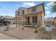 Charming two-story home featuring a well-manicured front yard and inviting covered porch at 17935 W Louise Dr, Surprise, AZ 85387