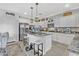 Open kitchen featuring granite countertops, an island with barstool seating, and stainless steel appliances at 17935 W Louise Dr, Surprise, AZ 85387