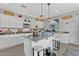 Bright kitchen featuring granite countertops, an island with barstool seating, and stainless steel appliances at 17935 W Louise Dr, Surprise, AZ 85387