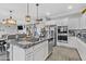 Kitchen featuring granite countertops, stainless steel appliances, view to the living room and an island at 17935 W Louise Dr, Surprise, AZ 85387