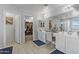Bright main bathroom with a vanity and a walk-in closet at 17935 W Louise Dr, Surprise, AZ 85387