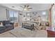 Well-lit main bedroom with a ceiling fan, bench, and decorative wall art at 17935 W Louise Dr, Surprise, AZ 85387