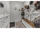 Bright mud room with custom storage bench and accent decor offers style and organization at 17935 W Louise Dr, Surprise, AZ 85387