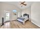 Comfortable bedroom with vaulted ceiling, ceiling fan, and sliding glass door to the yard at 18644 N 21St St, Phoenix, AZ 85024