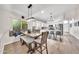 Bright dining area with a modern chandelier, a built-in bench, and direct views of the kitchen at 18644 N 21St St, Phoenix, AZ 85024