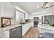 Bright kitchen with white cabinets, stainless steel appliances, and a window over the sink at 18644 N 21St St, Phoenix, AZ 85024