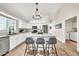 Spacious kitchen with white cabinets, granite countertops, island with seating, and stainless steel appliances at 18644 N 21St St, Phoenix, AZ 85024