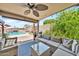 The outdoor patio with a ceiling fan has a view of the swimming pool at 18644 N 21St St, Phoenix, AZ 85024