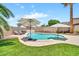 Backyard pool featuring a spacious patio area with lounging chairs and shade umbrellas at 18644 N 21St St, Phoenix, AZ 85024