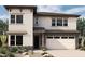 Modern two-story home with a neutral color scheme, stone accents, and a two-car garage at 1964 W Rowel Rd, Phoenix, AZ 85085