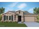 Beautiful single-story home with stylish stone accents, two-car garage, and well-maintained landscaping at 21599 W Pierson St, Buckeye, AZ 85396