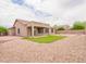 A nicely landscaped backyard with rocks and a patch of bright green grass at 22986 S 208Th St, Queen Creek, AZ 85142