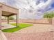 Well-maintained backyard featuring artificial turf, rock landscaping, and covered patio at 22986 S 208Th St, Queen Creek, AZ 85142