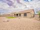 Spacious backyard with rock landscaping, artificial turf, and a covered patio area at 22986 S 208Th St, Queen Creek, AZ 85142