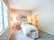 Bright bedroom with large window, ceiling fan, walk-in closet, and minimalist decor at 22986 S 208Th St, Queen Creek, AZ 85142