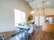 Open concept dining room featuring modern table set, with a view into the kitchen and home office area at 22986 S 208Th St, Queen Creek, AZ 85142