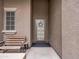 Inviting front entry with a decorative door and a comfortable bench at 22986 S 208Th St, Queen Creek, AZ 85142