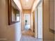 Inviting hallway with neutral tones, decorative mirror, and multiple entryways to other rooms at 22986 S 208Th St, Queen Creek, AZ 85142