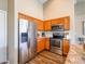 Well-lit kitchen featuring stainless steel appliances, granite countertops, and beautiful wood cabinetry at 22986 S 208Th St, Queen Creek, AZ 85142