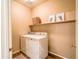 Functional laundry room with washer, dryer, storage shelf, and stylish decor at 22986 S 208Th St, Queen Creek, AZ 85142