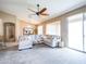 Bright living room featuring neutral tones, large windows, and a sliding glass door for a seamless indoor-outdoor flow at 22986 S 208Th St, Queen Creek, AZ 85142