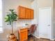 Home office nook with granite countertop, storage cabinets, and natural light from nearby window at 22986 S 208Th St, Queen Creek, AZ 85142