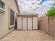 White shed with double doors for extra storage in the backyard at 22986 S 208Th St, Queen Creek, AZ 85142