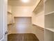 Spacious walk-in closet featuring multiple shelves and rods for optimal storage and organization at 22986 S 208Th St, Queen Creek, AZ 85142