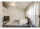 Bedroom featuring gray bedding, white walls, and a ceiling fan at 2301 E University Dr # 488, Mesa, AZ 85213