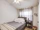 Bedroom featuring gray bedding, white walls, ceiling fan and curtains at 2301 E University Dr # 488, Mesa, AZ 85213