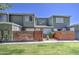 Attractive two-story townhouse with fresh green paint, a small yard, and a brick accent wall for added privacy at 2301 E University Dr # 488, Mesa, AZ 85213